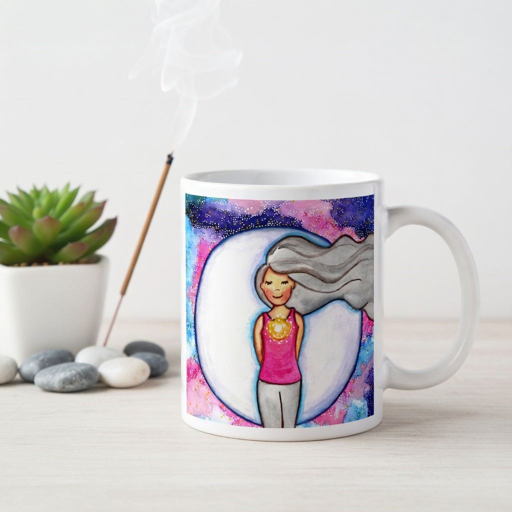 Meditating person with glowing heart chakra at center of chest, symbolizing love, compassion and emotional balance, spiritual design on a mindfulness coffee mug.  Incense is burning behind the mug. There is a green potted plant in the background.