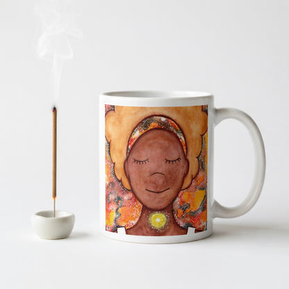 Meditating figure with glowing throat chakra, symbolizing communication, truth and self-expression, spiritual mindfulness artwork on a coffee mug.  Incense is burning beside the mug. 