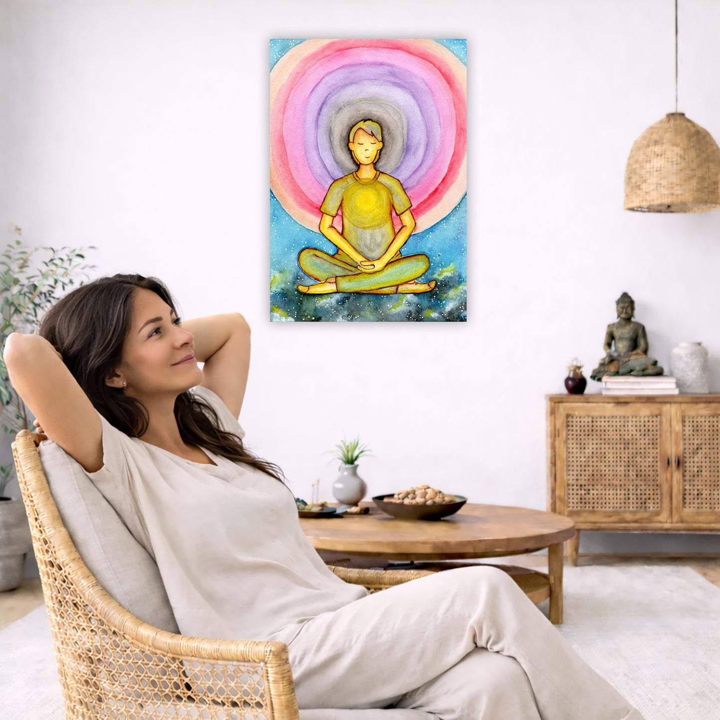 Canvas of a young man's heart chakra glowing and aura energy flowing around him. This is a print of the original hand-painted watercolor by Brazilian artist Thaís Suizo for the LET'S MEDITATE SERIES of mediation guides.  The poster is in the center of the living room wall. To the right a woman is relaxing in a chair with her hands behind her head. To the left is a green floor plant and a hanging green plant. To the right of her is a green floor plant.
