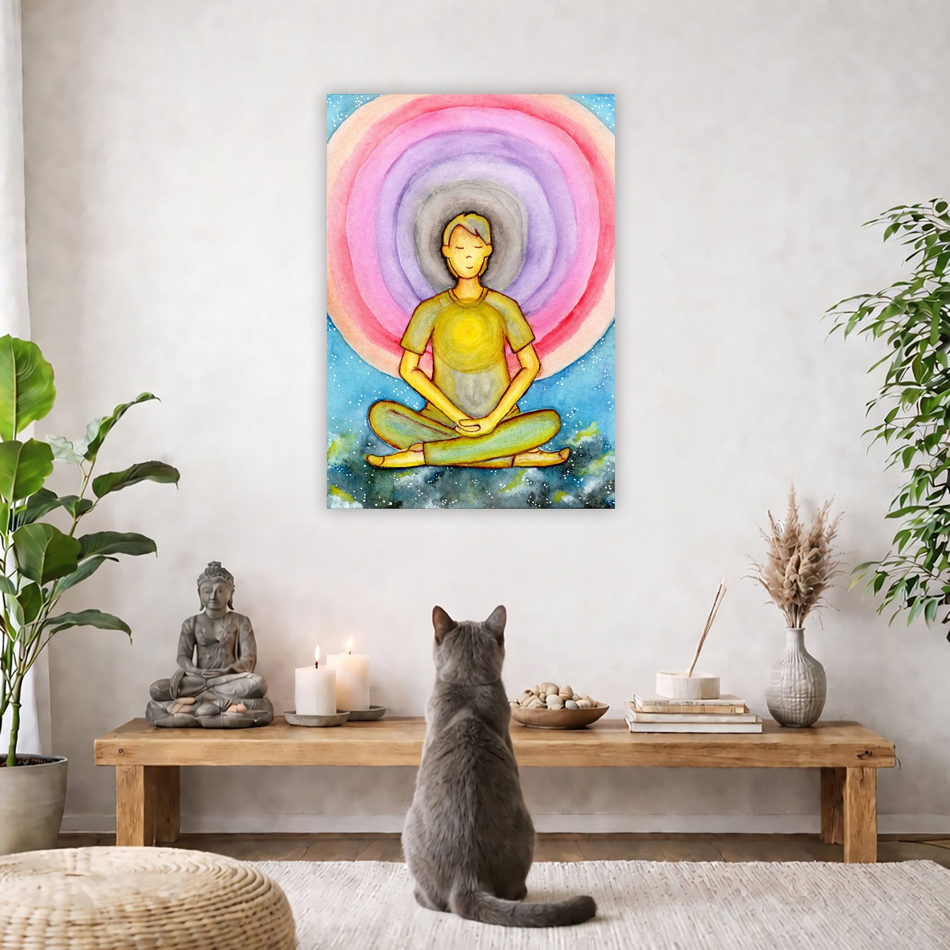 Canvas of a young man's heart chakra glowing and aura energy flowing around him. This is a print of the original hand-painted watercolor by Brazilian artist Thaís Suizo for the LET'S MEDITATE SERIES of mediation guides.  The poster is in the center of the living room wall. A gray cat is facing the poster. In front of it is a coffee table with a Buddha statue and burning candle on the left and incense and an orange cat staring at the poster on the right. There is a green potted plant on both sides.