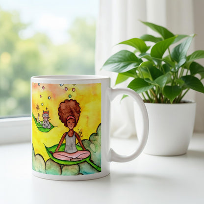 Woman and cat sitting peacefully on leaves in meditation, nature-inspired mindfulness scene representing calm, balance and connection, printed on a spiritual coffee mug.  There is a window, curtains and a green potted plant behind the mug.