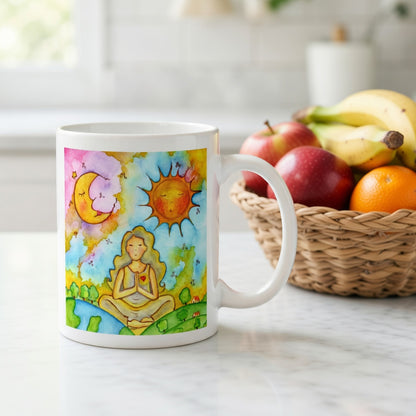Woman in meditation with sun and moon cosmic design on mug.  Beside the mug is a basket of fruit.