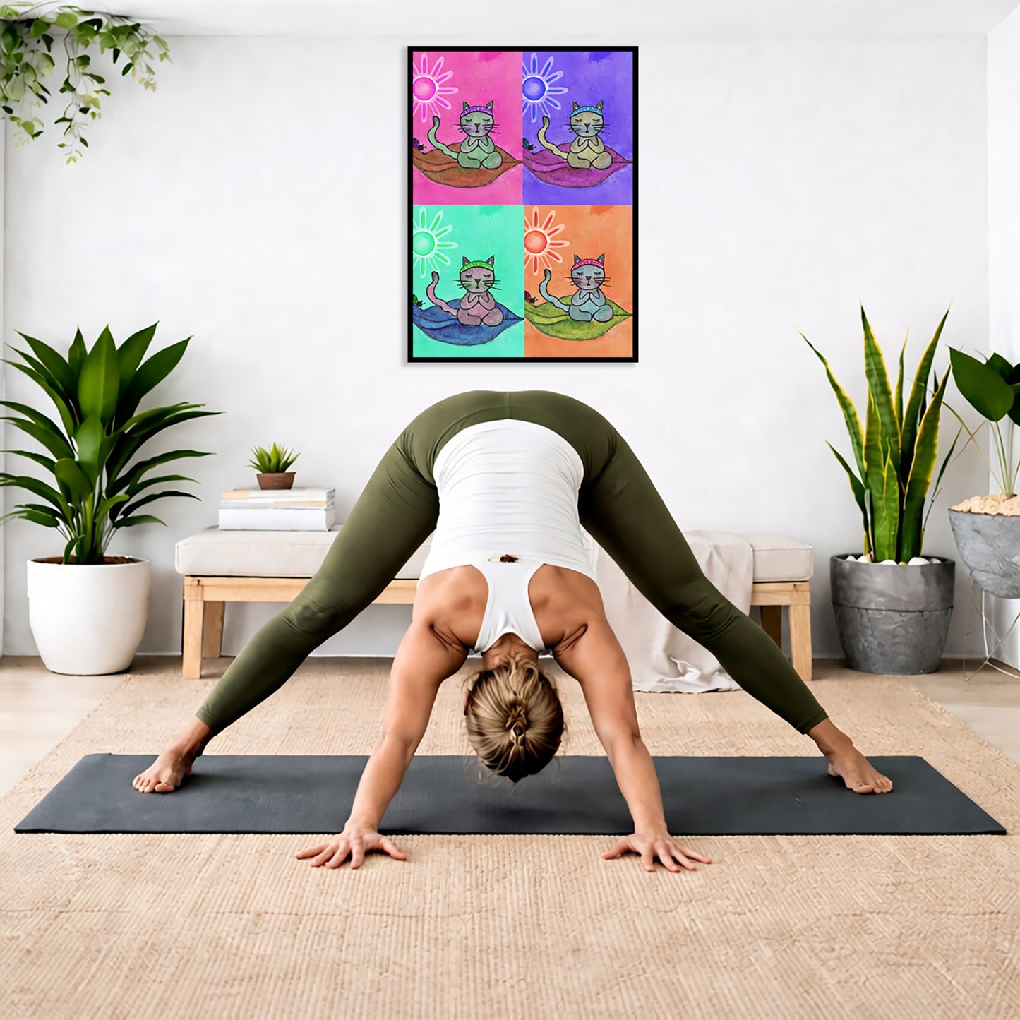 Multi colored grid of four cats meditating on a leaf framed poster. This is a print of the original hand-painted watercolor by Brazilian artist Thaís Suizo. The poster is in the center of the living room wall. Below the poster a woman is doing the yoga posture downward facing dog on a yoga mat.