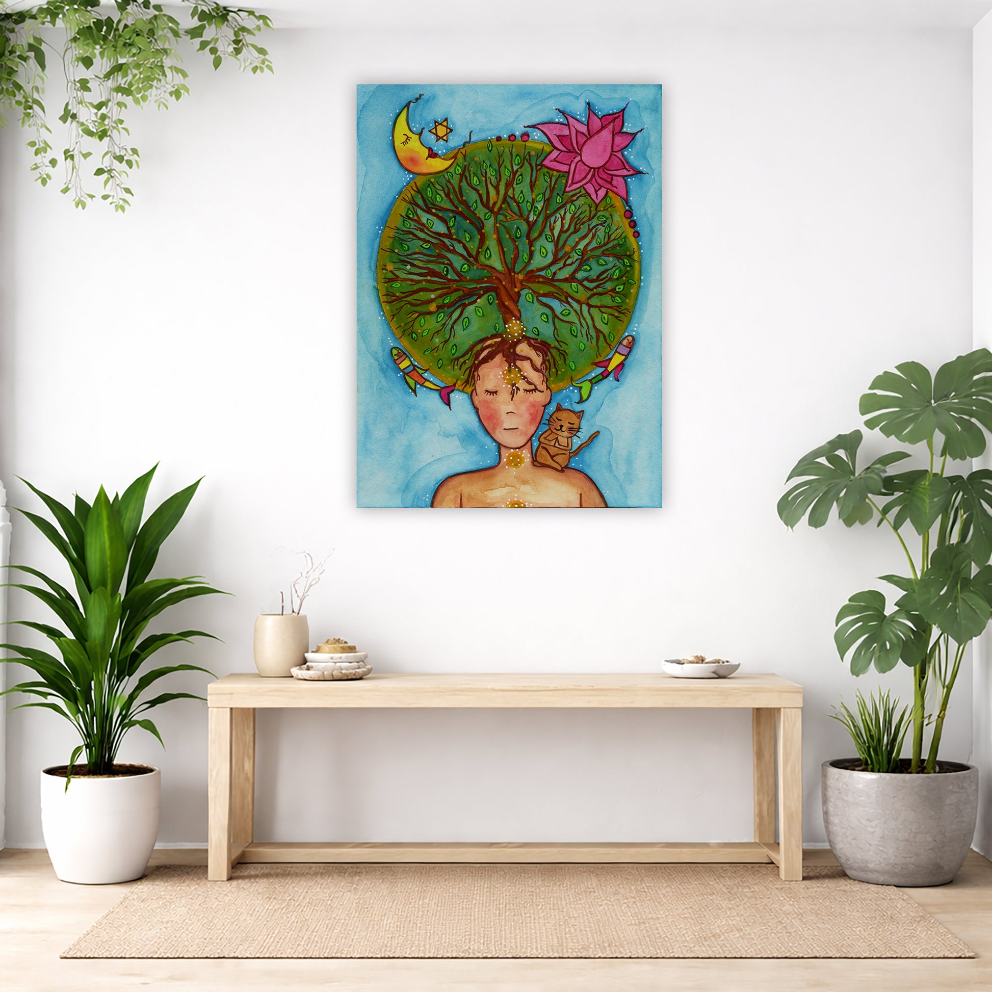 canvas of a woman meditating with her crown chakra blooming into the tree of life. Her cat is sitting on her shoulder.  The poster is in the center of the living room wall. Below the poster is an empty bench. Below the bench is a variety of green potted plants including a few cactus.
