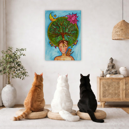 canvas of a woman meditating with her crown chakra blooming into the tree of life. Her cat is sitting on her shoulder.  The poster framed is hanging on the wall. Three cats are staring up at the poster, orange, white and black. There is a potted plant on the left side and a cabinet with a Buddha statue, books and incense on the right side.
