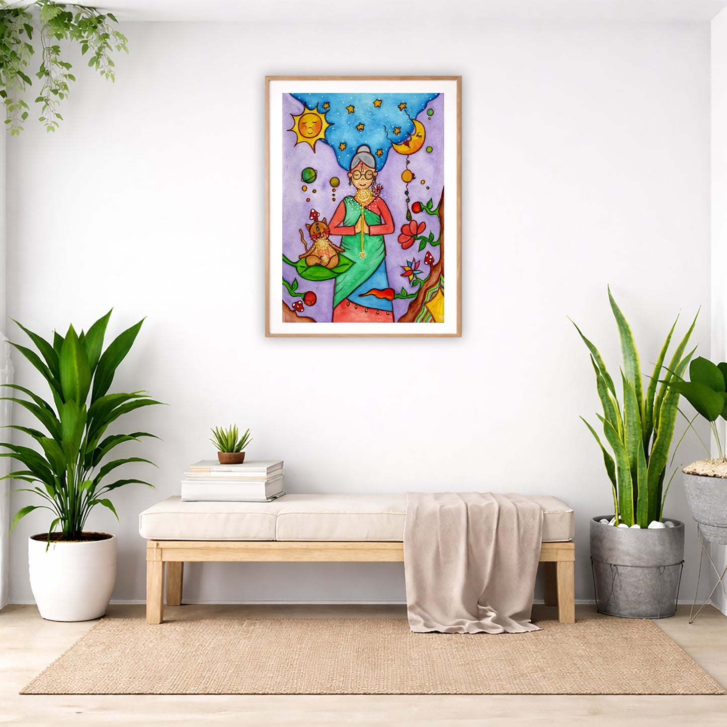 Poster of a woman's throat chakra energy glowing.  The poster is framed and is in the center of the living room wall. Below the poster is a padded bench. On the bench is a pile of books and a small green potted plant. There is a silk sheet draped over the bench. There is a green hanging plant and floor plant on the left. There are two floor plants on the right.