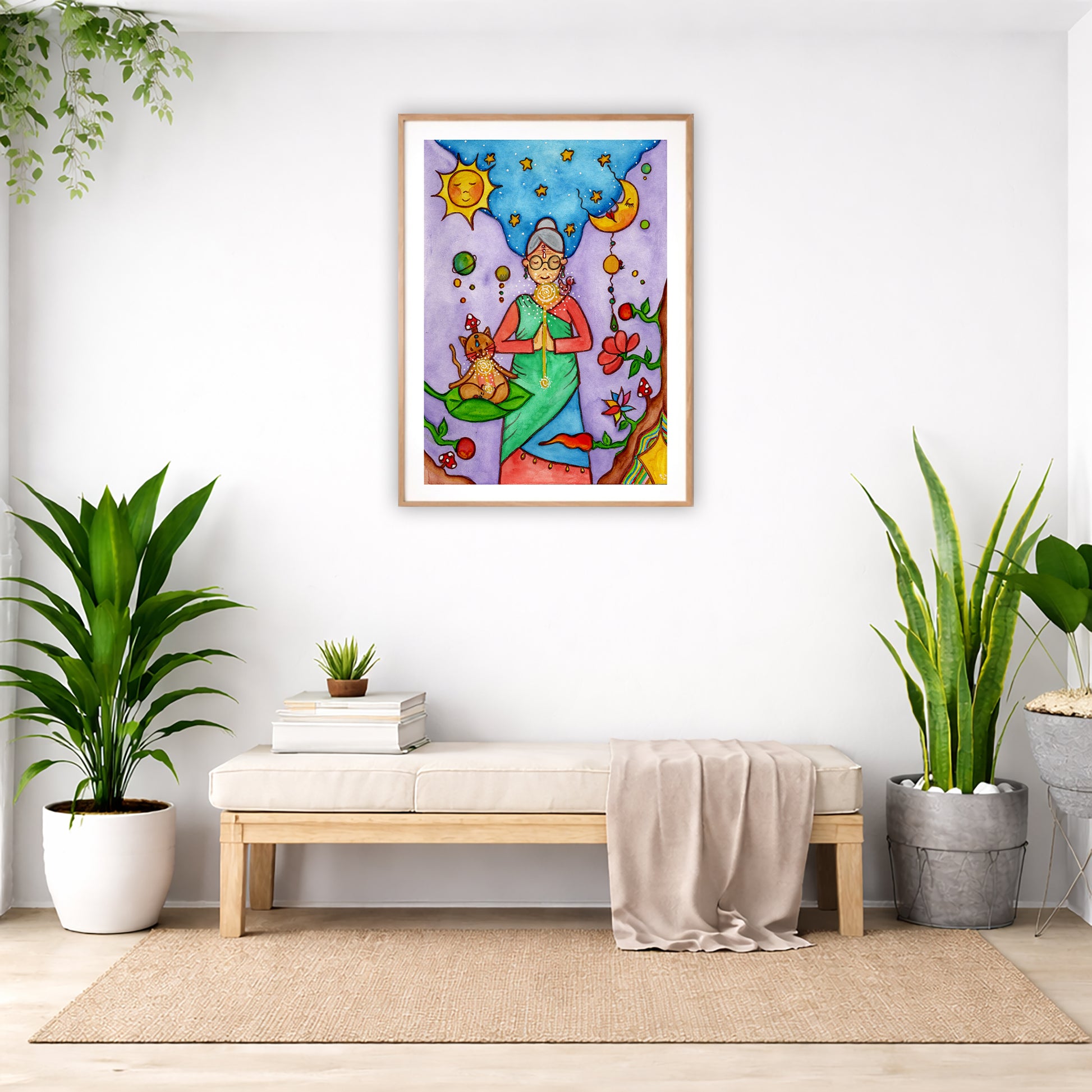 Poster of a woman's throat chakra energy glowing.  The poster is framed and is in the center of the living room wall. Below the poster is a padded bench. On the bench is a pile of books and a small green potted plant. There is a silk sheet draped over the bench. There is a green hanging plant and floor plant on the left. There are two floor plants on the right.