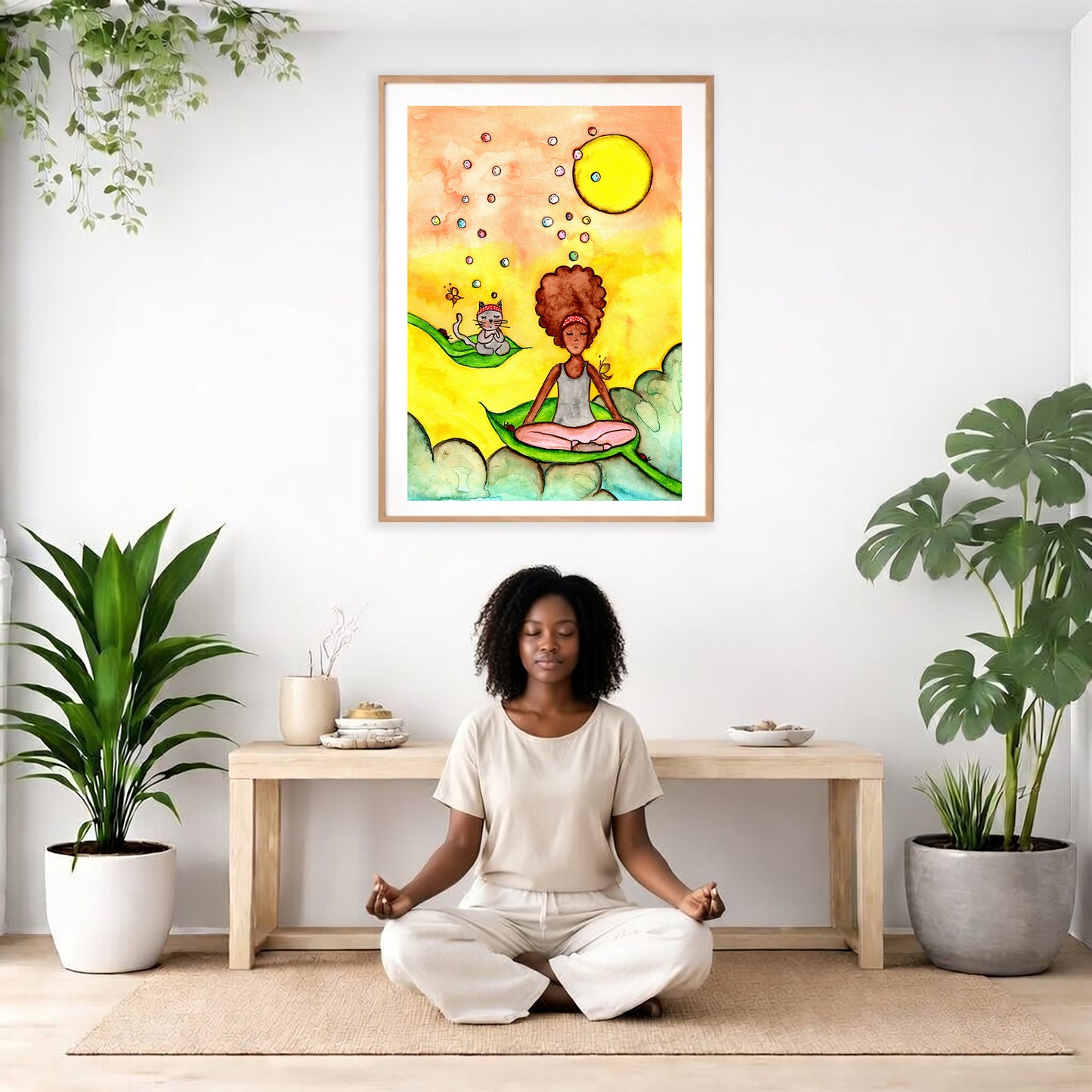 Poster of a woman and a cat meditating on a leaf with a yellow sunny background. The poster is framed and is in the center of the living room wall. There is a woman meditating facing away from the wall. Behind her is a coffee table with incense and a Buddha statue. There are potted plants on the right and left side of the background.
