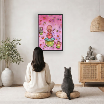 Poster of a woman and her cats meditating atop their own personal worlds with a pink background. The poster is framed and is in the center of the living room wall. A woman and a cat are staring up at the poster. There is a potted plant on the left side and a cabinet with a Buddha statue, books and incense on the right side.
