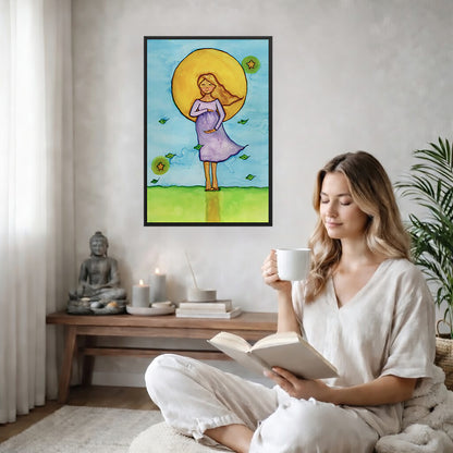 Woman standing in meditation under a bright sun with soft blue sky background, framed watercolor print.  The poster is on the back wall in the living room. There is a coffee table below the poster with burning candles and a big piece of driftwood. A woman is sitting in a wicker chair on the right side of the poster with a cup of tea reading a book. There is a potted green plant behind her.