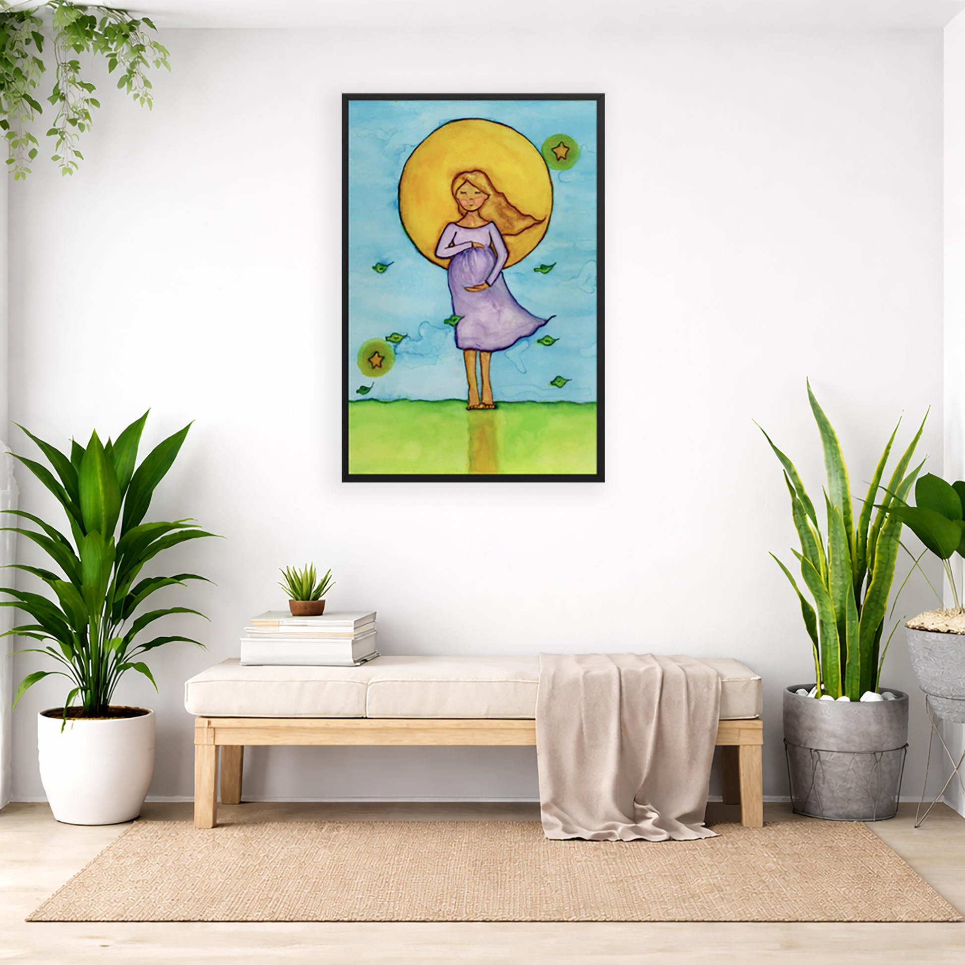 Woman standing in meditation under a bright sun with soft blue sky background, framed watercolor print.  The poster is framed and is in the center of the living room wall. Below the poster is a padded bench. On the bench is a pile of books and a small green potted plant. There is a silk sheet draped over the bench. There is a green hanging plant and floor plant on the left. There are two floor plants on the right.