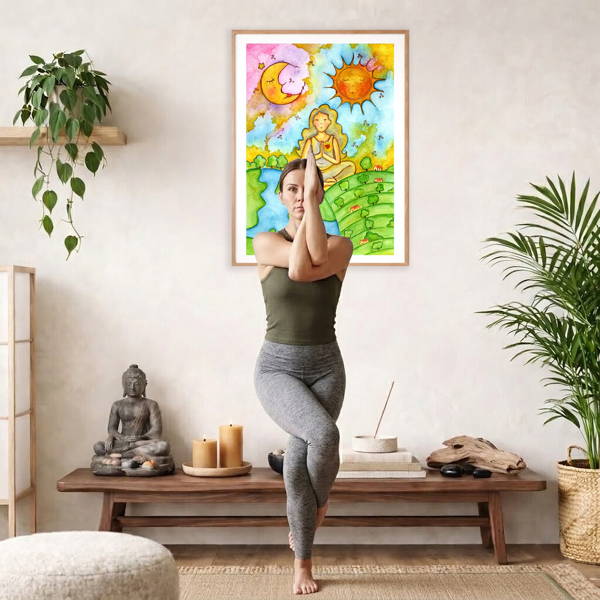 Poster of a woman meditating beneath the sun and moon cosmic design.  The poster is framed and is in the center of the living room wall. A woman is doing a sitting forward bend on her yoga mat. There is a coffee table below the poster with burning candles, incense, a Buddha statue and a big piece of driftwood.
