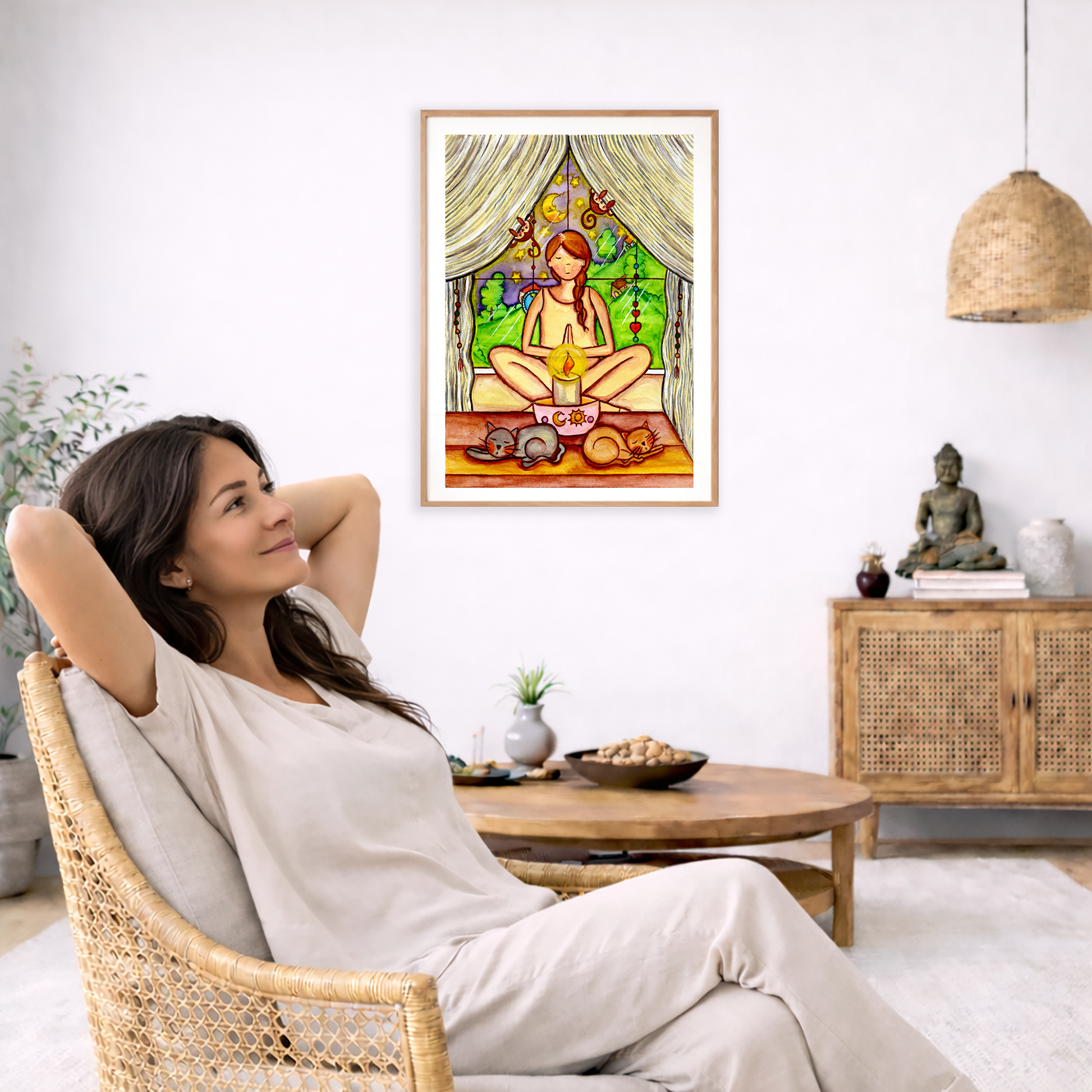 Candlelight trataka meditation design on mindfulness poster. The poster is framed and is in the center of the living room wall. To the left a woman is relaxing in her chair with her hands behind her head. There is a small coffee table beside her with a bowl of walnuts, incense and a small green plant. On the right side of the room is a cabinet with a Buddha statue, books and an urn on it. To the left is a green floor plant.