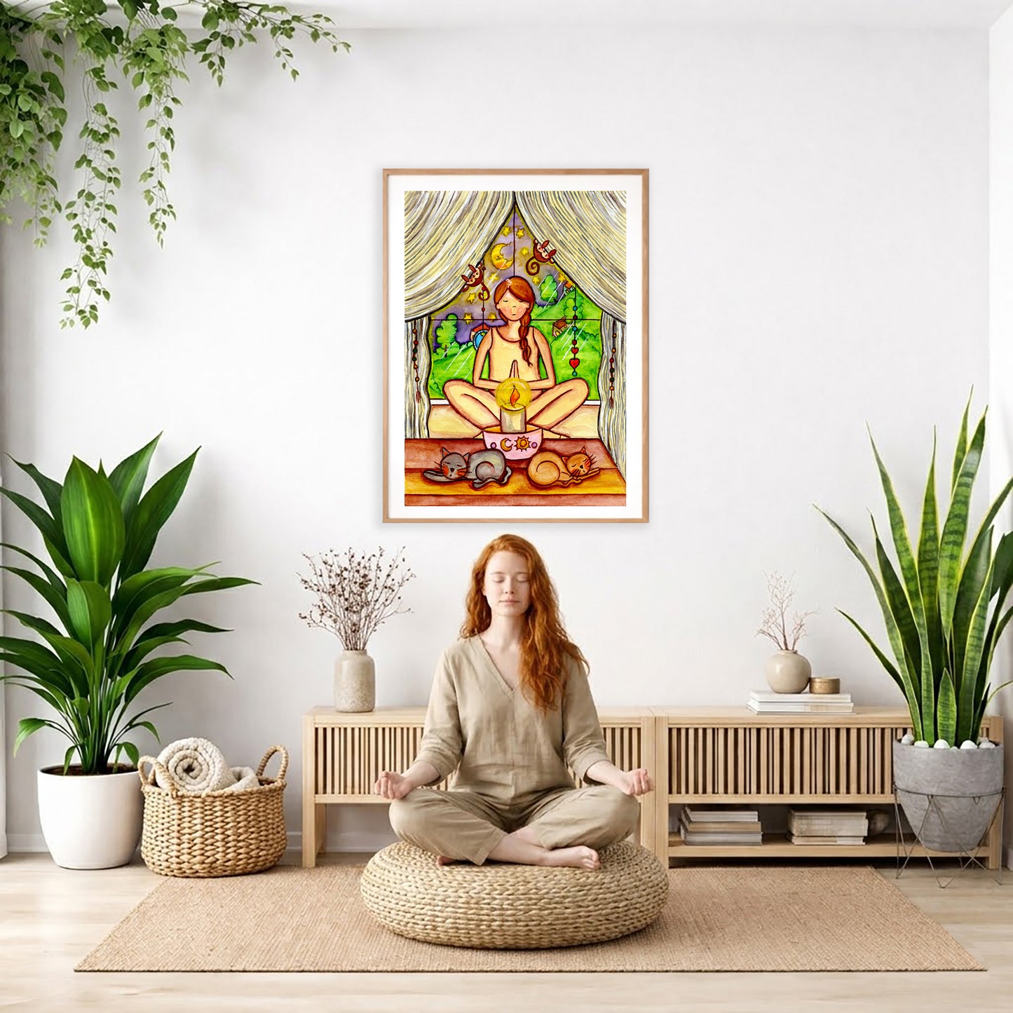 Candlelight trataka meditation design on mindfulness poster. The poster is framed and is in the center of the living room wall. There is a woman meditating facing away from the wall. Behind her is a coffee table with incense and a Buddha statue. There are potted plants on the right and left side of the background.

