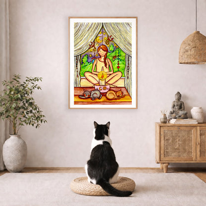 Candlelight trataka meditation design on mindfulness poster.  The poster is framed and is in the center of the living room wall. A black and white cat is staring at the poster. There is a potted plant on the left side and a cabinet with a Buddha statue on it on the right side. 