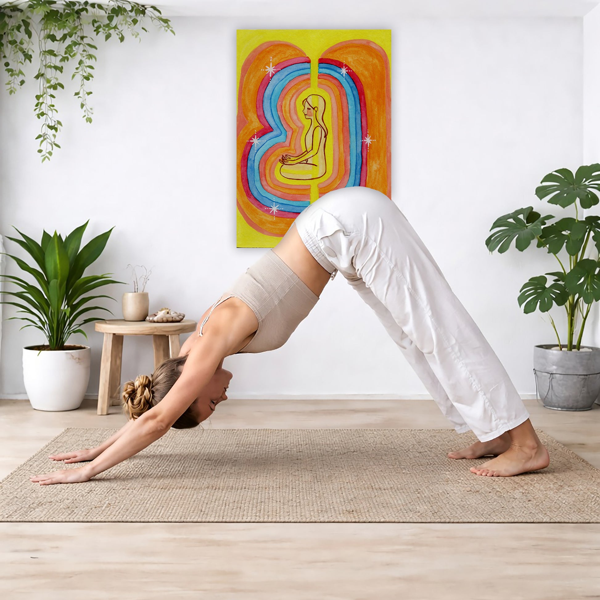 Rainbow aura energy field portrait on mindfulness canvas poster.  The poster is framed and is in the center of the living room wall. Below the poster a woman is doing the yoga posture downward facing dog on a wicker yoga mat.