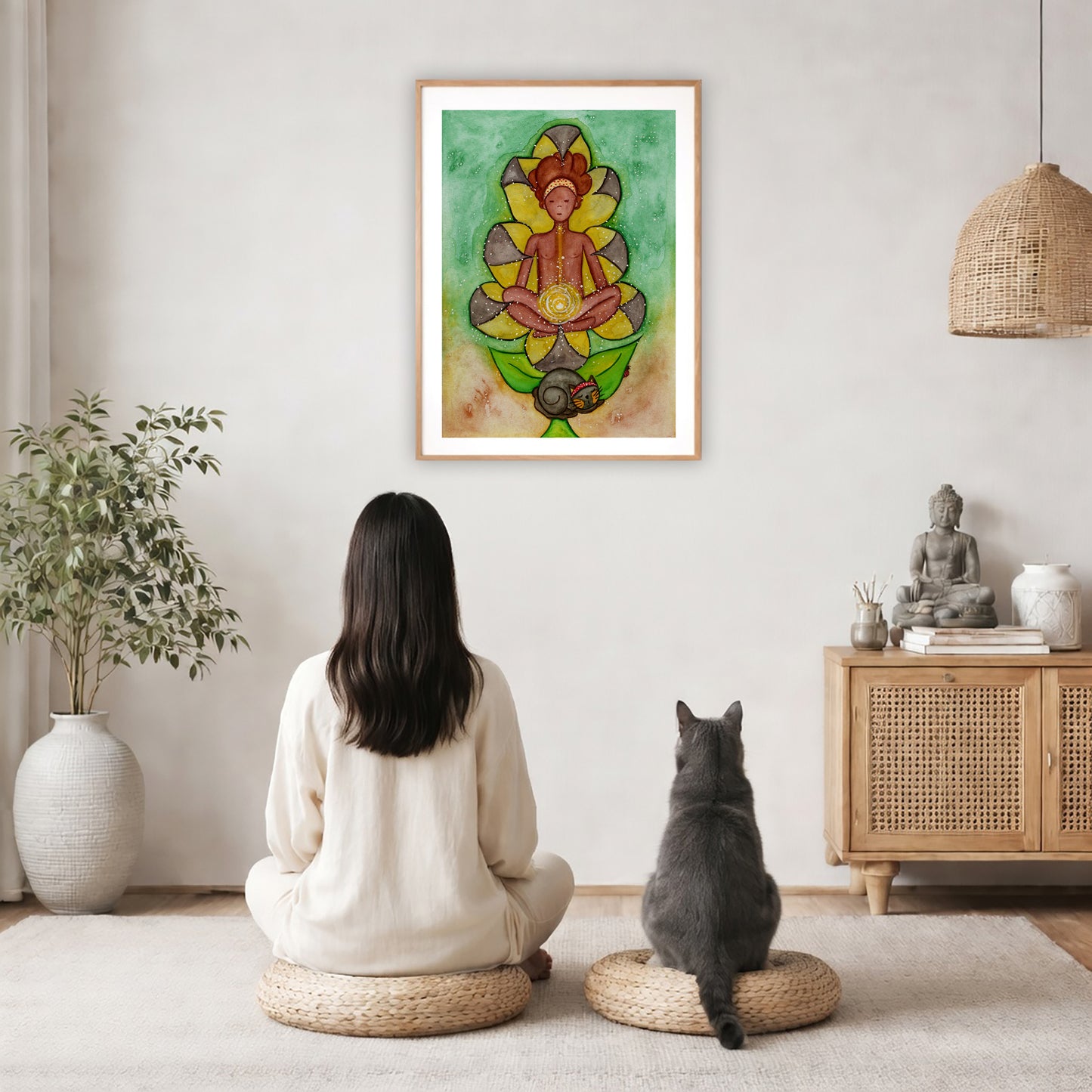 Poster of a woman's sacral chakra glowing and the energy around her.   The poster is in the center of the living room wall. A woman and a cat are staring up at the poster. There is a potted plant on the left side and a cabinet with a Buddha statue, books and incense on the right side.
 