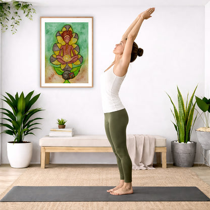 Poster of a woman's sacral chakra glowing and the energy around her.  The poster is in the center of the living room wall. A woman is doing a sun salutation on her yoga mat. There is a coffee table below the poster with burning candles, incense, a Buddha statue and a big piece of driftwood.

