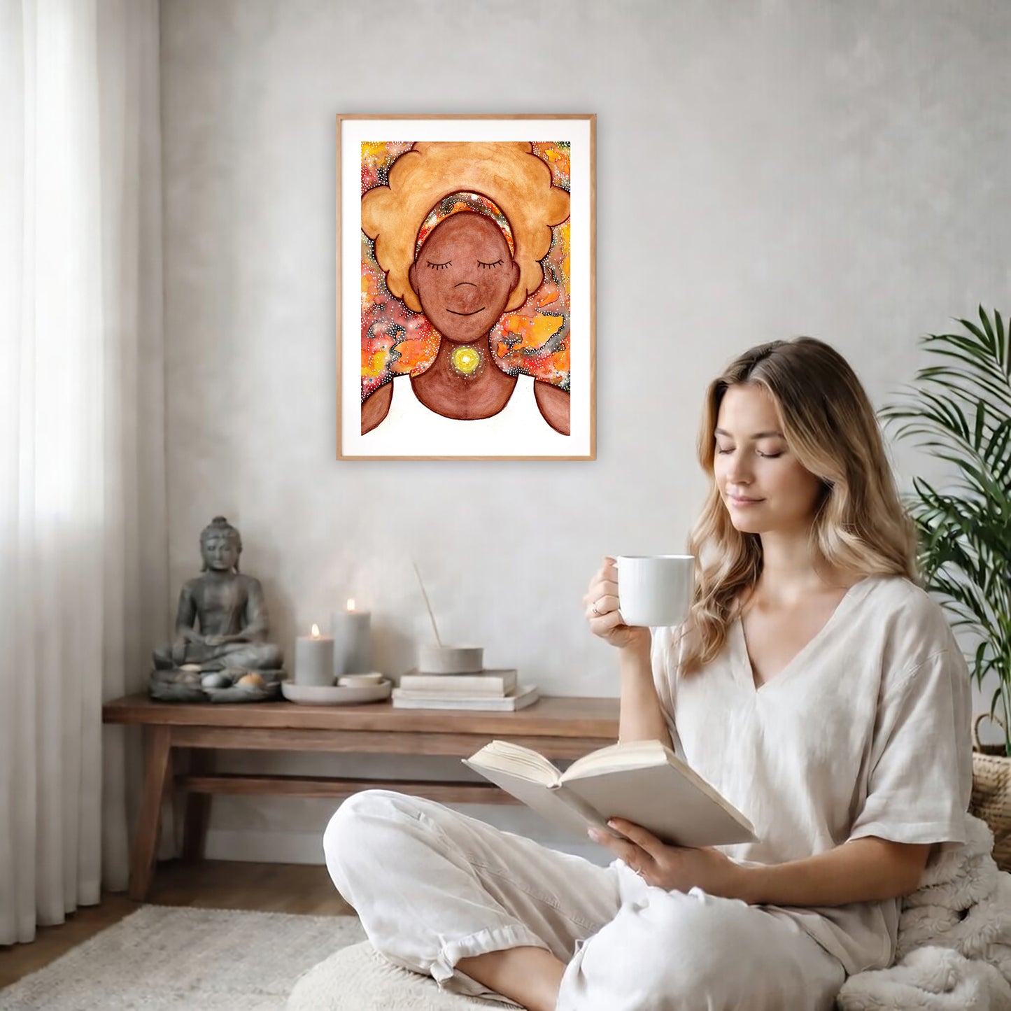 Poster of a woman's throat chakra energy glowing.  The poster is on the back wall in the living room. There is a coffee table below the poster with burning candles and a big piece of driftwood. A woman is sitting in a wicker chair on the right side of the poster with a cup of tea reading a book. There is a potted green plant behind her.