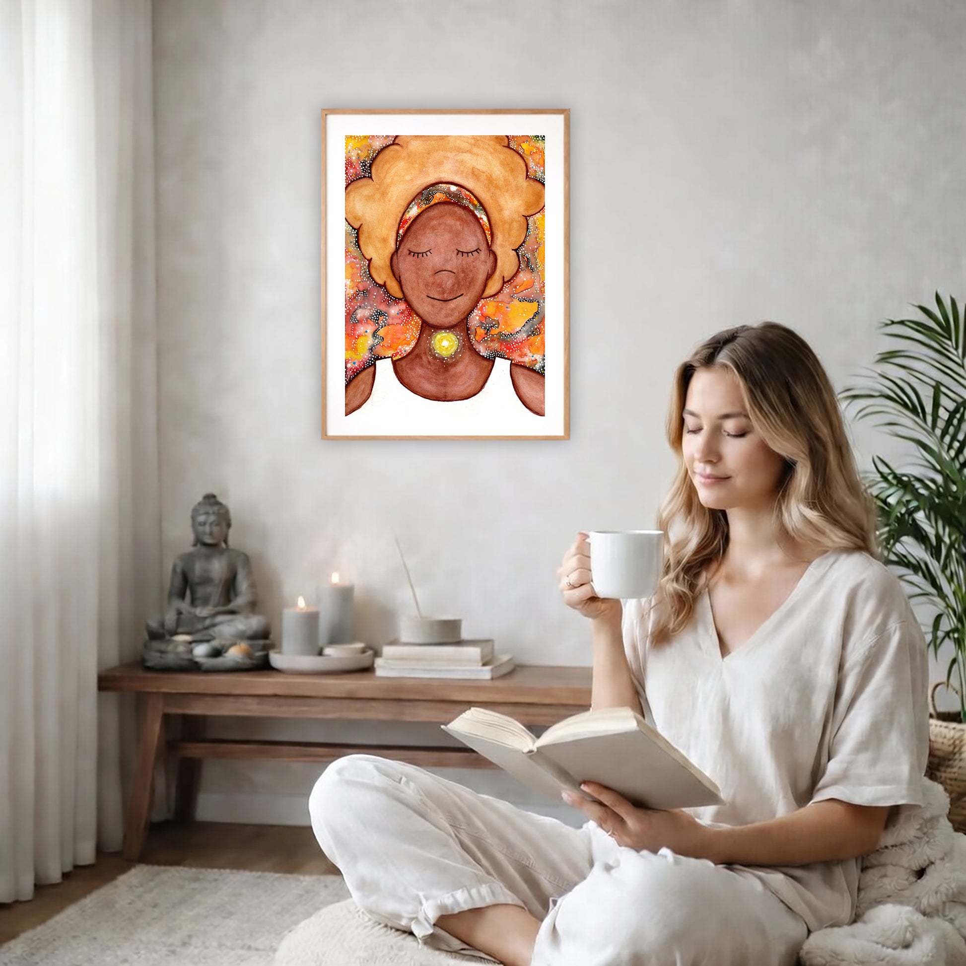 Poster of a woman's throat chakra energy glowing.  The poster is on the back wall in the living room. There is a coffee table below the poster with burning candles and a big piece of driftwood. A woman is sitting in a wicker chair on the right side of the poster with a cup of tea reading a book. There is a potted green plant behind her.