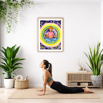Poster of a young man meditating with his solar plexus glowing. Surrounding him is his colorful aura.  The poster is hanging on the wall. A woman on her yoga mat is doing the cobra pose in front of the poster. There is a potted plant and a hanging plant on the left side. A padded bench with material draped over it is behind her. On the right side are two potted plants.
