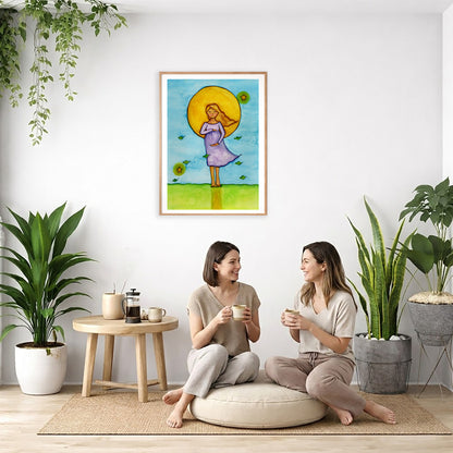 Woman standing in meditation under a glowing sun with blue sky background, calming watercolor spiritual illustration.  The poster is framed and is in the center of the living room wall. Two women are sitting on a giant pillow having a coffee. Beside them is a small tray with a pot of coffee and incense. To the left is a green floor plant and a hanging green plant. To the right of them is a green floor plant.