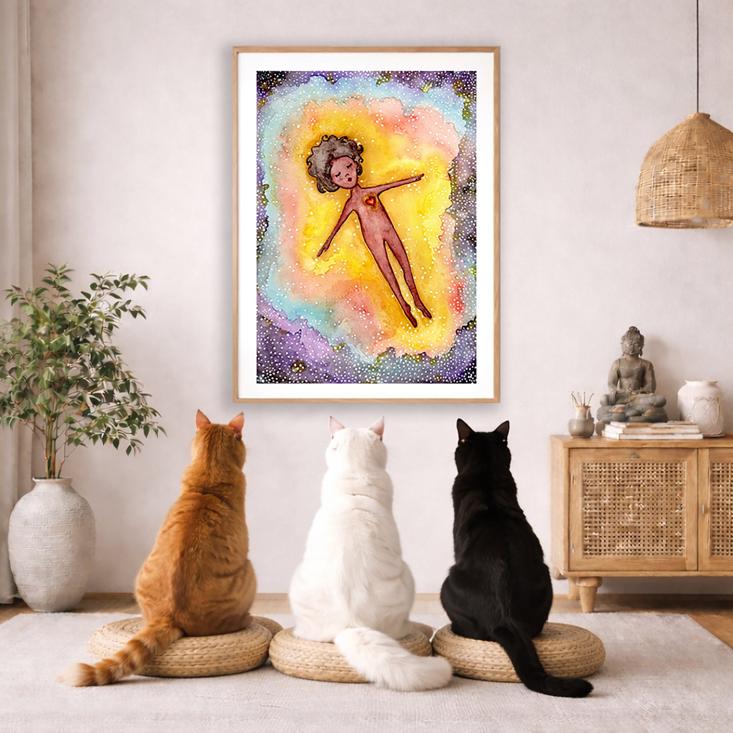 Full sized poster of an astral body relaxing in the space of another dimension. The poster framed is hanging on the wall. Three cats are staring up at the poster, orange, white and black. There is a potted plant on the left side and a cabinet with a Buddha statue, books and incense on the right side.