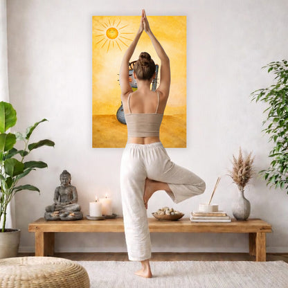 Poster of a gray cat meditating peacefully on a sunny day with warm light and calm surroundings.  The poster is framed hanging on a living room wall. A woman is doing the yoga tree pose (Vrksasana) facing the poster. There is a coffee table in front of her with candles and a Buddha statue. There are green potted plants on each side of the room.
