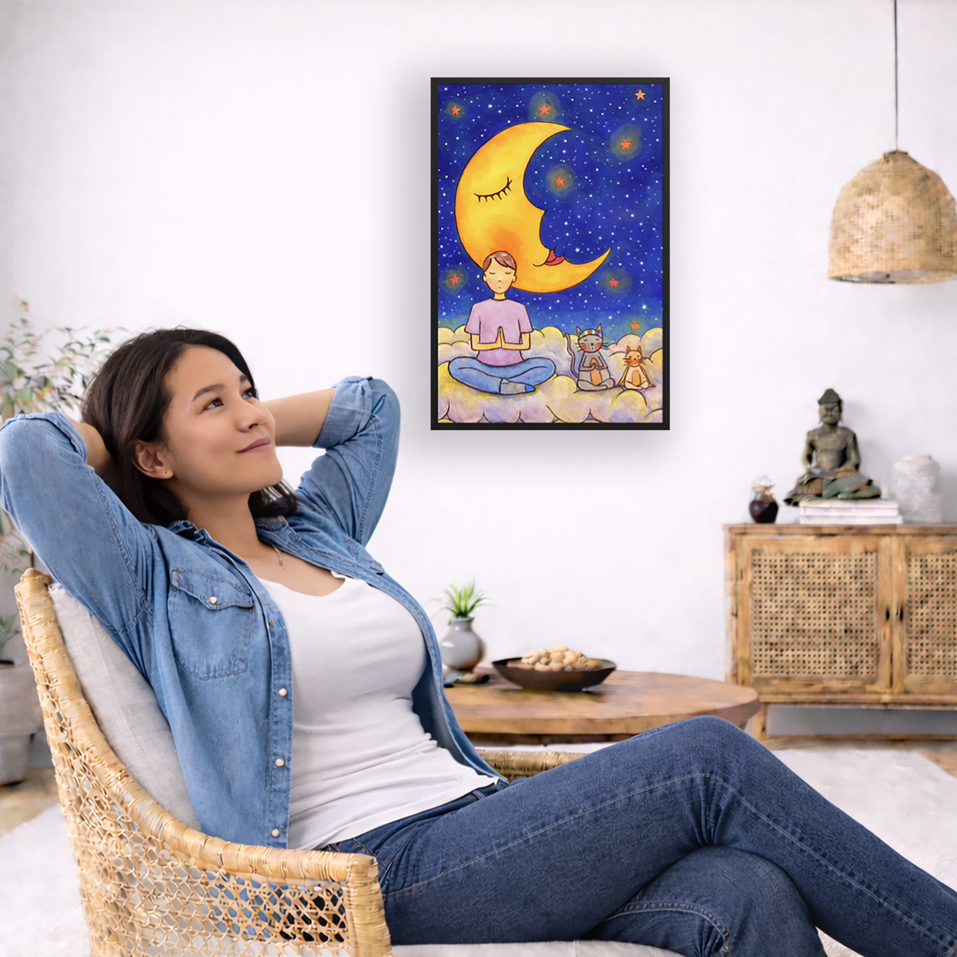 A man and his cats meditate together sitting on a cloud under the moon and the night sky. The poster is framed and is in the center of the living room wall. To the left a woman is relaxing in her chair with her hands behind her head. There is a small coffee table beside her with a bowl of walnuts, incense and a small green plant. On the right side of the room is a cabinet with a Buddha statue, books and an urn on it. To the left is a green floor plant.
