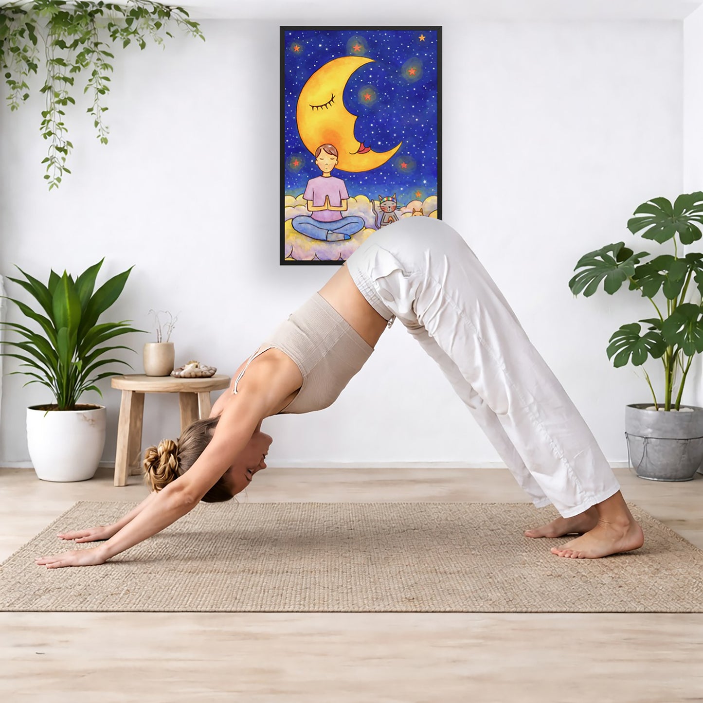 A man and his cats meditate together sitting on a cloud under the moon and the night sky.  The poster is framed and is in the center of the living room wall. Below the poster a woman is doing the yoga posture downward facing dog on a wicker yoga mat.