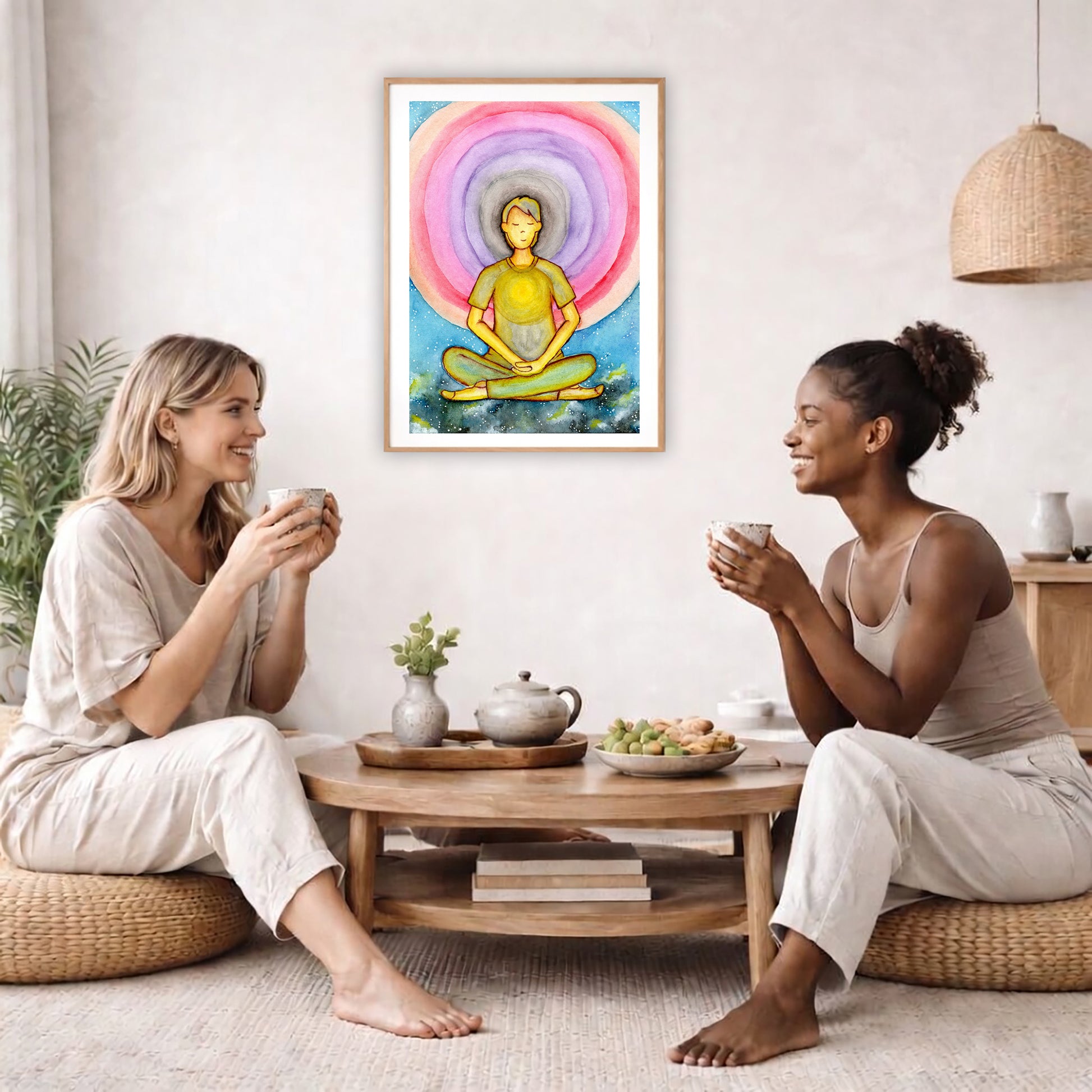Poster of a young man's heart chakra glowing and aura energy flowing around him.  The poster is in the center of the living room wall. Two female friends are having tea, grapes and cookies on a coffee table in front of the poster. On the left there is a green potted plant and to the right there is a hanging lamp.
