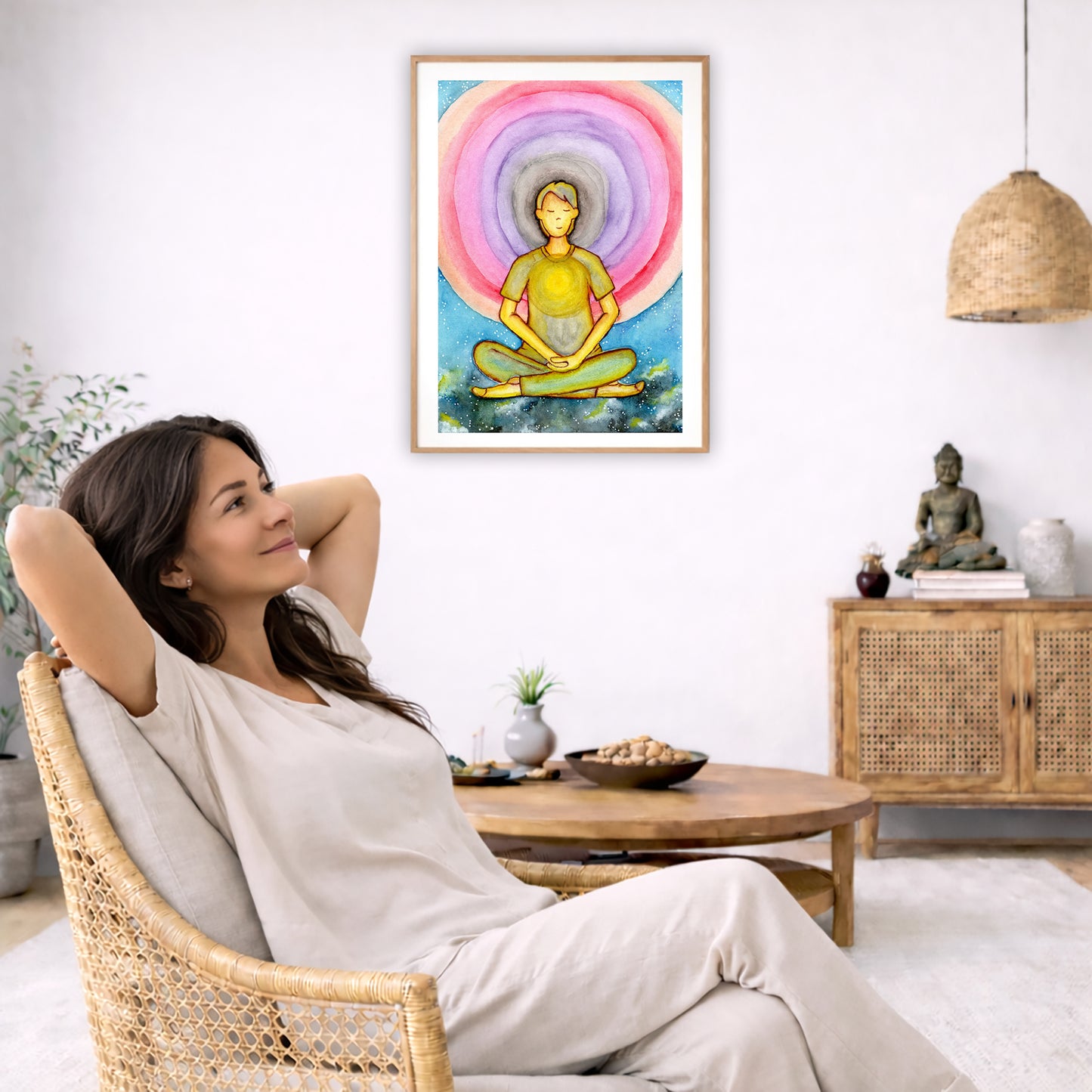 Poster of a young man's heart chakra glowing and aura energy flowing around him.  The poster is in the center of the living room wall. To the left a woman is relaxing in her chair with her hands behind her head. There is a small coffee table beside her with a bowl of walnuts, incense and a small green plant. On the right side of the room is a cabinet with a Buddha statue, books and an urn on it. To the left is a green floor plant.