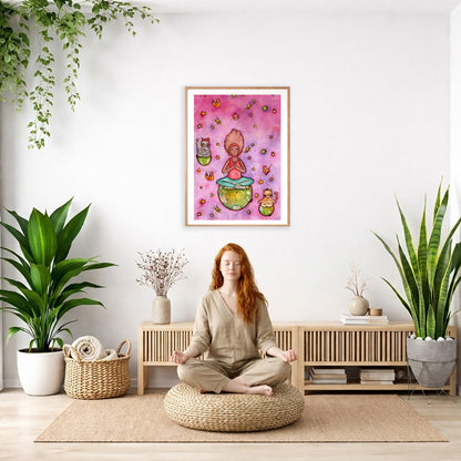 A woman and her cats meditating on the world with a pink background poster. The poster is framed and is in the center of the living room wall. There is a woman meditating facing away from the wall. Behind her is a coffee table with incense and a Buddha statue. There are potted plants on the right and left side of the background.

