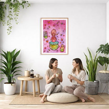 A woman and her cats meditating on the world with a pink background poster.  The poster is framed and is in the center of the living room wall. Two women are sitting on a giant pillow having a coffee. Beside them is a small tray with a pot of coffee and incense. To the left is a green floor plant and a hanging green plant. To the right of them is a green floor plant.