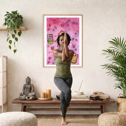 A woman and her cats meditating on the world with a pink background poster.  The poster is framed hanging on a living room wall. A woman is doing the yoga tree pose (Vrksasana) facing the poster. There is a coffee table in front of her with candles and a Buddha statue. There are green potted plants on each side of the room.
