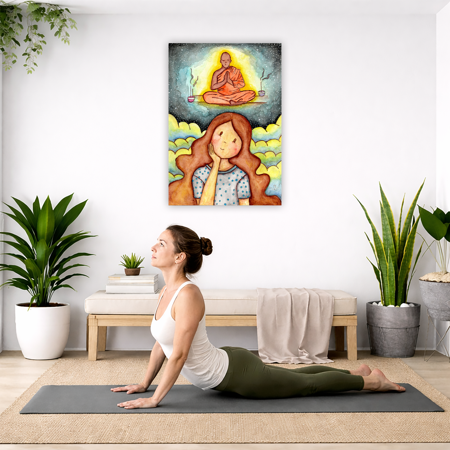Poster of woman imagining the higher power that will guide her as she learns to meditate.  The poster is hanging on the wall. A woman on her yoga mat is doing the cobra pose in front of the poster. There is a potted plant, a hanging plant and a basket of cloth material on the left side. On the right side of her is a small cabinet books and a dry plant. There is also a floor plant on the right side.