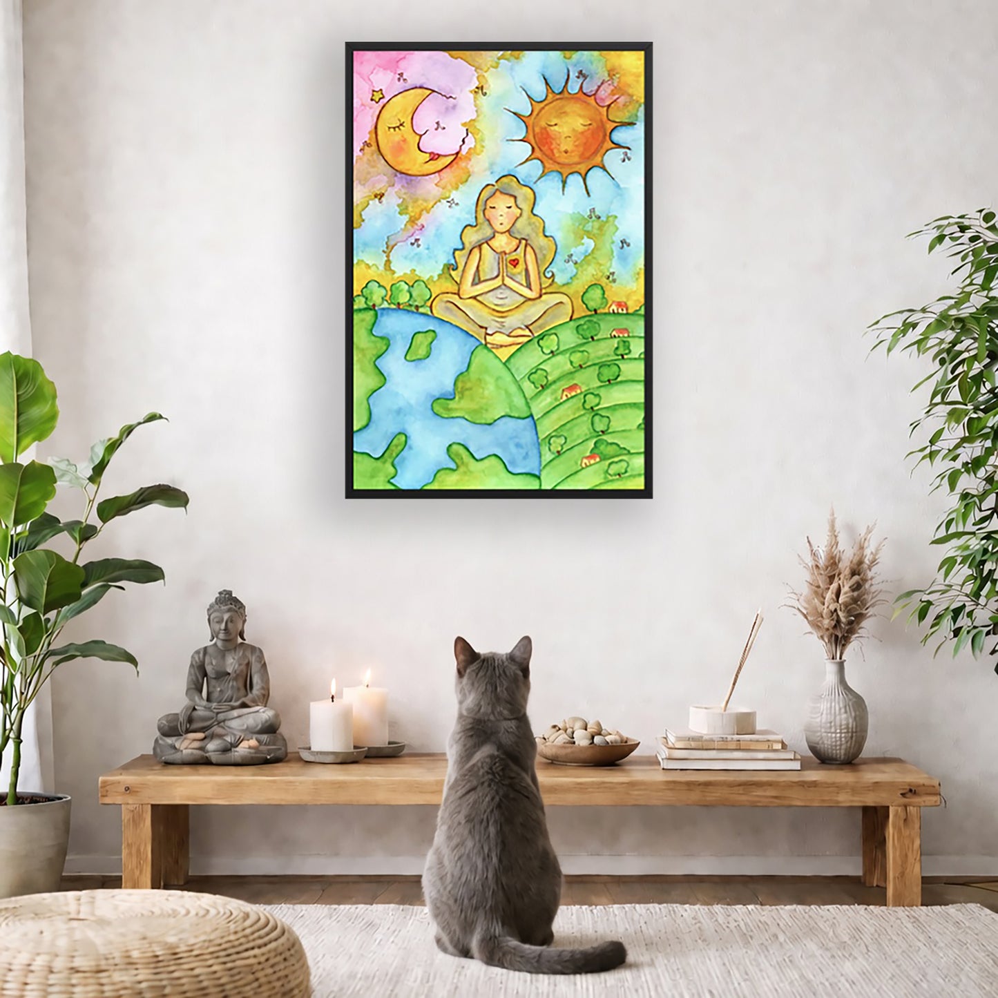 Poster of a woman meditating beneath the sun and moon in a cosmic design. The poster is framed and is in the center of the living room wall. A gray cat is facing the poster. In front of it is a coffee table with a Buddha statue and burning candle on the left and incense and an orange cat staring at the poster on the right. There is a green potted plant on both the left and right side of the coffee table.