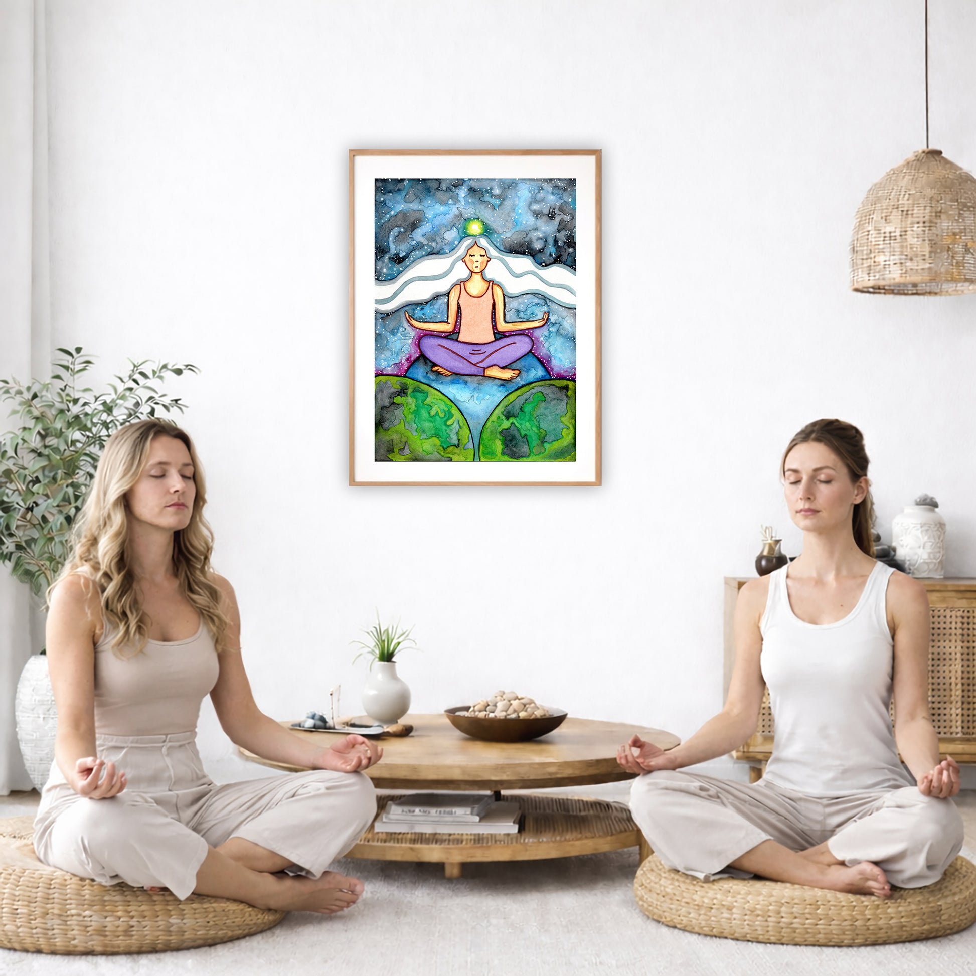 Poster of a woman meditating on three worlds with her crown chakra glowing.  The poster is in the center of the living room wall. Two women are sitting on wicker pillows meditating. Behind them is a small round coffee table with incense, a green potted plant and a bowl of shells. There is a potted plant to the left and a Buddha statue and a vase to the right. 