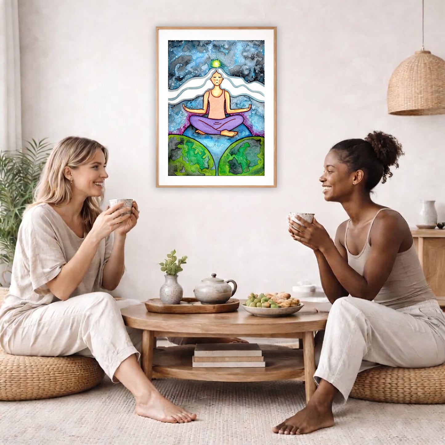 Poster of a woman meditating on three worlds with her crown chakra glowing.  The poster is in the center of the living room wall. Two female friends are having tea, grapes and cookies on a coffee table in front of the poster. On the left there is a green potted plant and to the right there is a hanging lamp.
