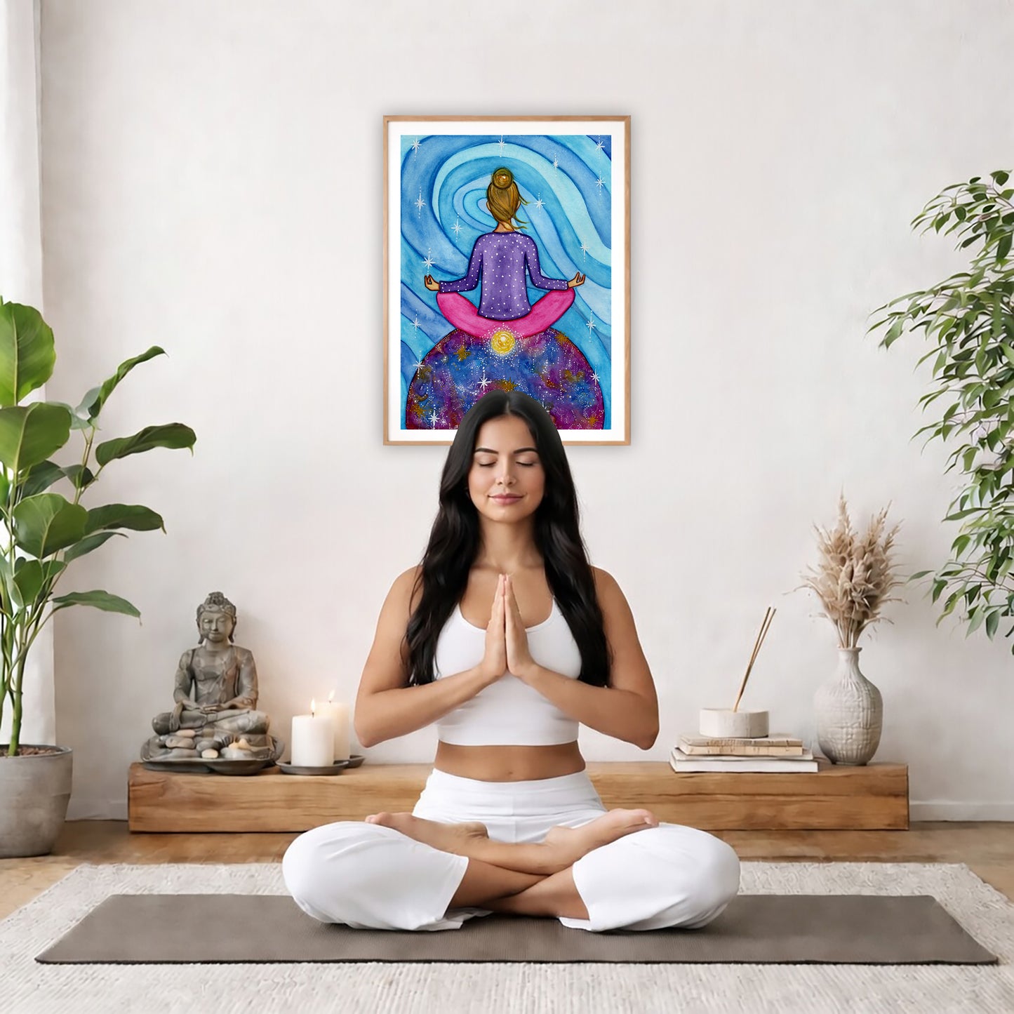 Poster of a woman meditating with her root chakra glowing.  The poster is in the center of the living room wall. There is a woman meditating facing away from the wall. Behind her is a coffee table with incense and a Buddha statue. There are potted plants on the right and left side of the background.
