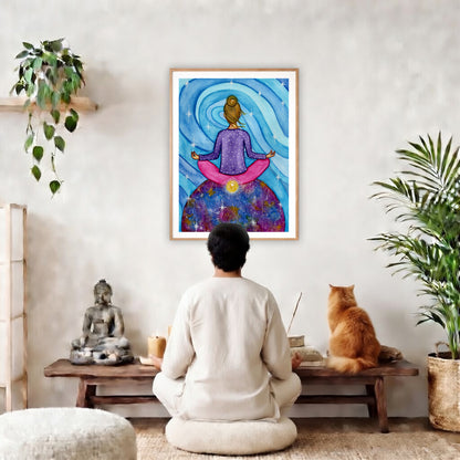 Poster of a woman meditating with her root chakra glowing.  The poster is in the center of the living room wall. A man is meditating facing the poster. In front of him is a coffee table with a Buddha statue and burning candle on the left and incense and an orange cat staring at the poster on the right. There is a green potted plant on both the left and right side of the coffee table.