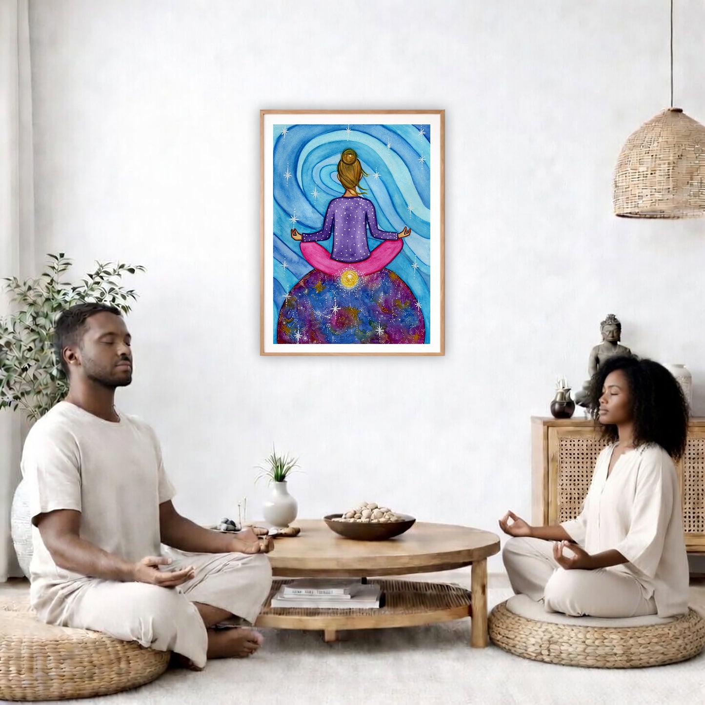 Poster of a woman meditating with her root chakra glowing.  The poster is in the center of the living room wall. Two friends are sitting on wicker pillows meditating. Between them is a small round coffee table with incense, a green potted plant and a bowl of shells. There is a potted plant to the left and a Buddha statue and a vase to the right. 