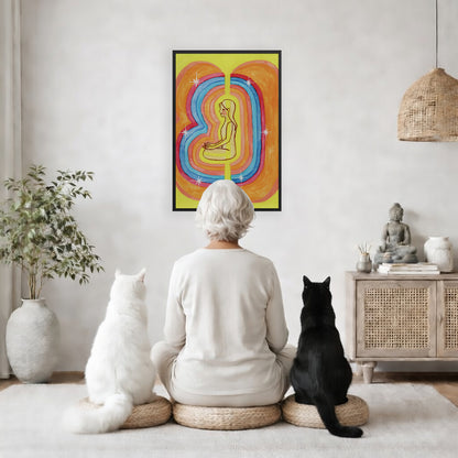 Rainbow aura energy field portrait on mindfulness framed poster.  The poster is framed and is in the center of the living room wall. A woman is meditating facing the poster with a white cat on her left side and a black cat on her right side. There is a potted plant on the left side and a cabinet with a Buddha statue on it on the right side. 