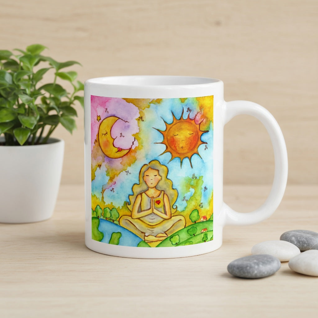 Woman in meditation with sun and moon cosmic design on mug.  Beside the mug are meditation stones. Behind the mug is a green potted plant.
