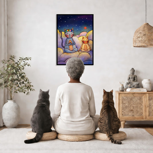 Two cats meditating on a cloud at night under the stars framed poster. This is a print of the original illustration by Brazilian artist Thaís Suizo.  The poster is in the center of the living room wall. A woman is meditating facing the poster with a white cat on her left side and a black cat on her right side. There is a potted plant on the left side and a cabinet with a Buddha statue on it on the right side. 
