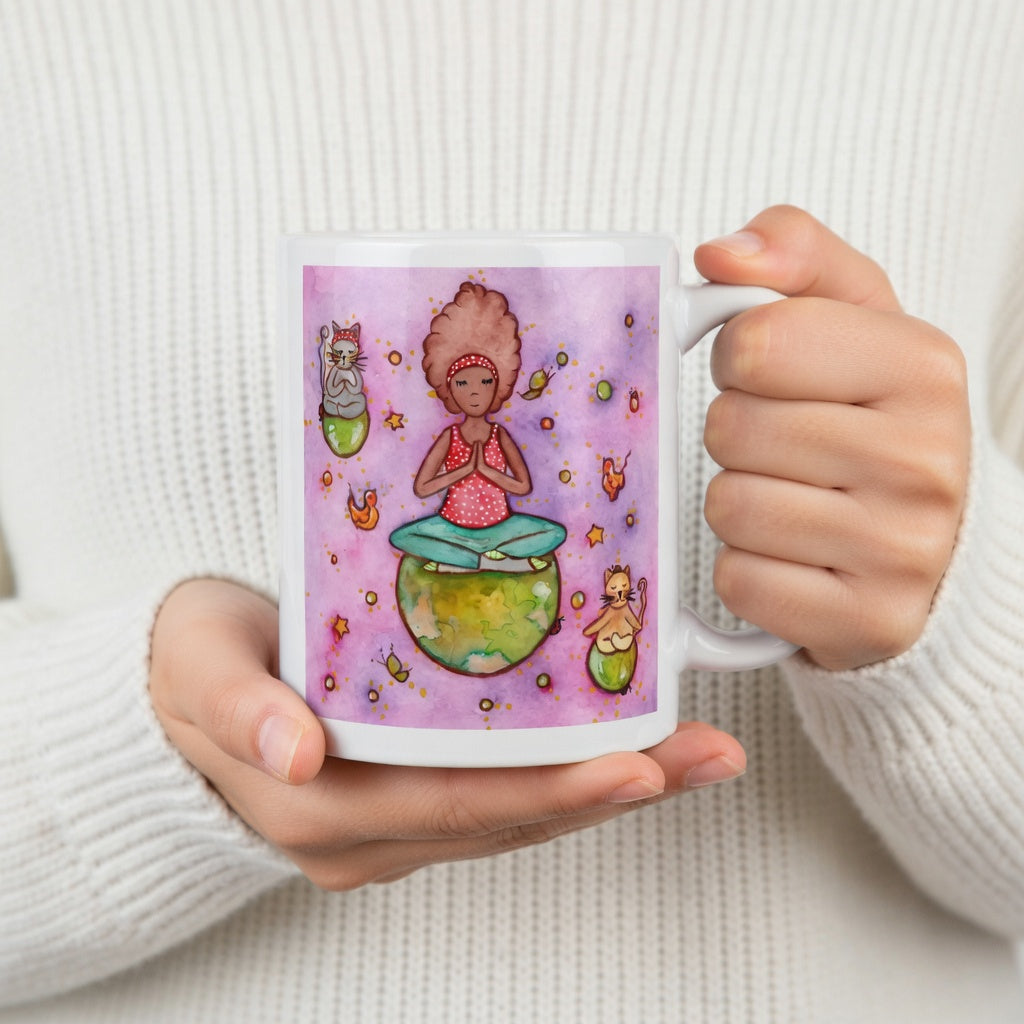 Woman and multiple cats meditating while sitting on the world, symbolizing unity, peace and global mindfulness, unique spiritual mug design.  The hands of a person wearing a white sweater are holding the mug up to display the design.
