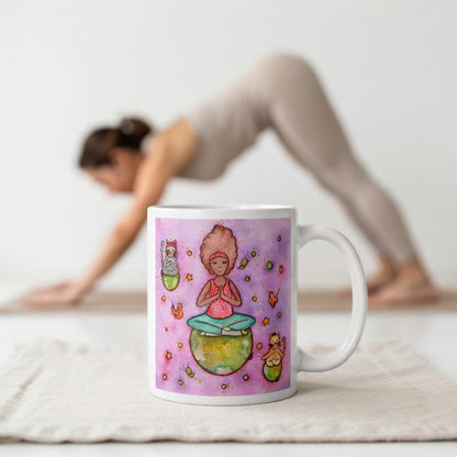 Woman and multiple cats meditating while sitting on the world, symbolizing unity, peace and global mindfulness, unique spiritual mug design. The mug is in front of a woman doing the yoga posture downward facing dog.