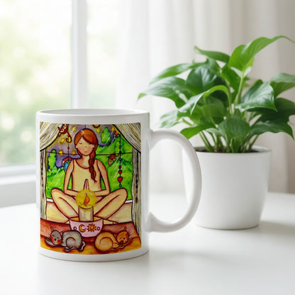 Candlelight trataka meditation design on mindfulness mug. Two cats are sleeping in front of the lady as she meditates. The mug is sitting on a white cloth. There is a window, curtains and a green potted plant behind the mug.
