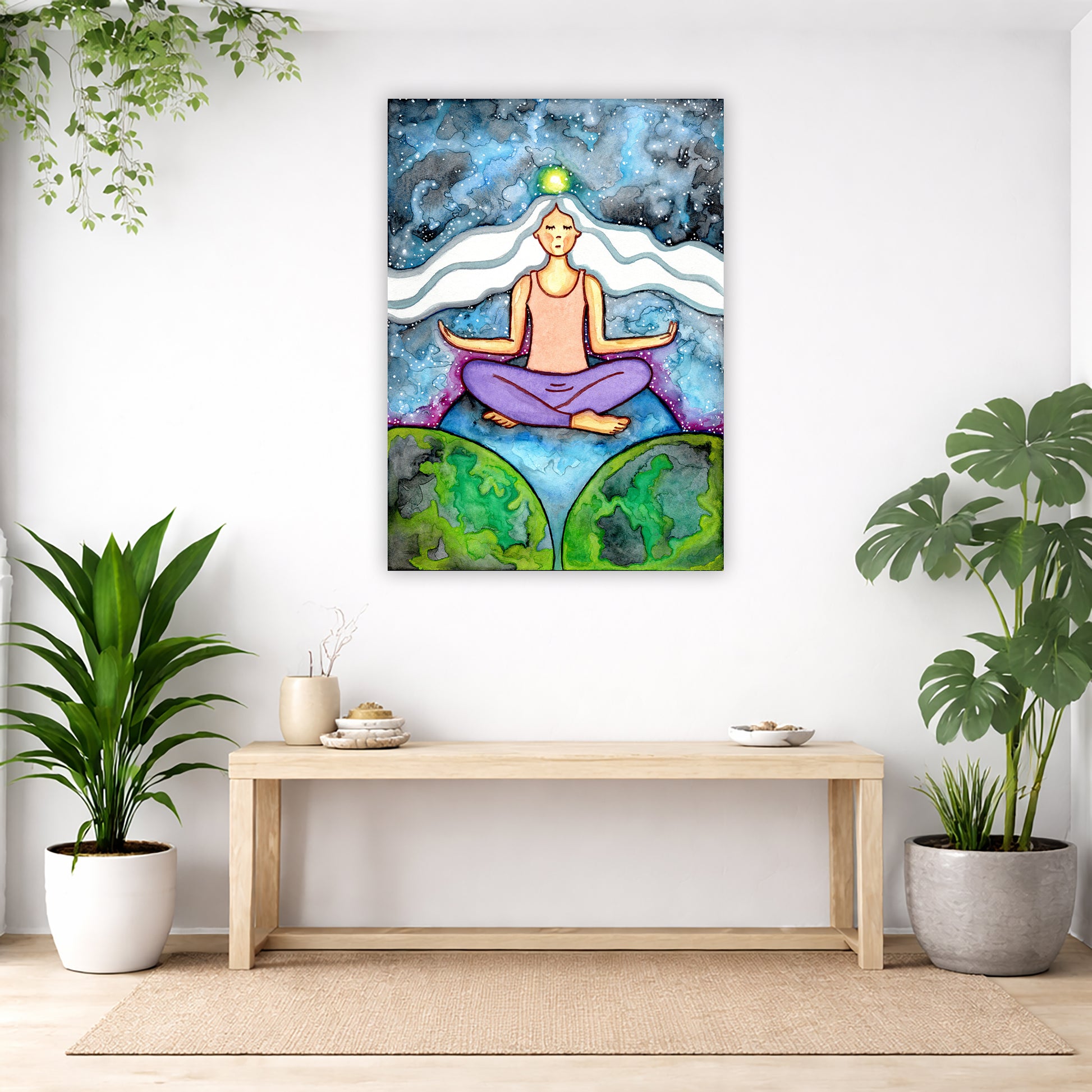Woman with crown chakra glowing canvas poster. She is sitting on top of the world.  The poster is in the center of the living room wall. Below the poster is an empty bench. Below the bench is a variety of green potted plants including a few cactus.
