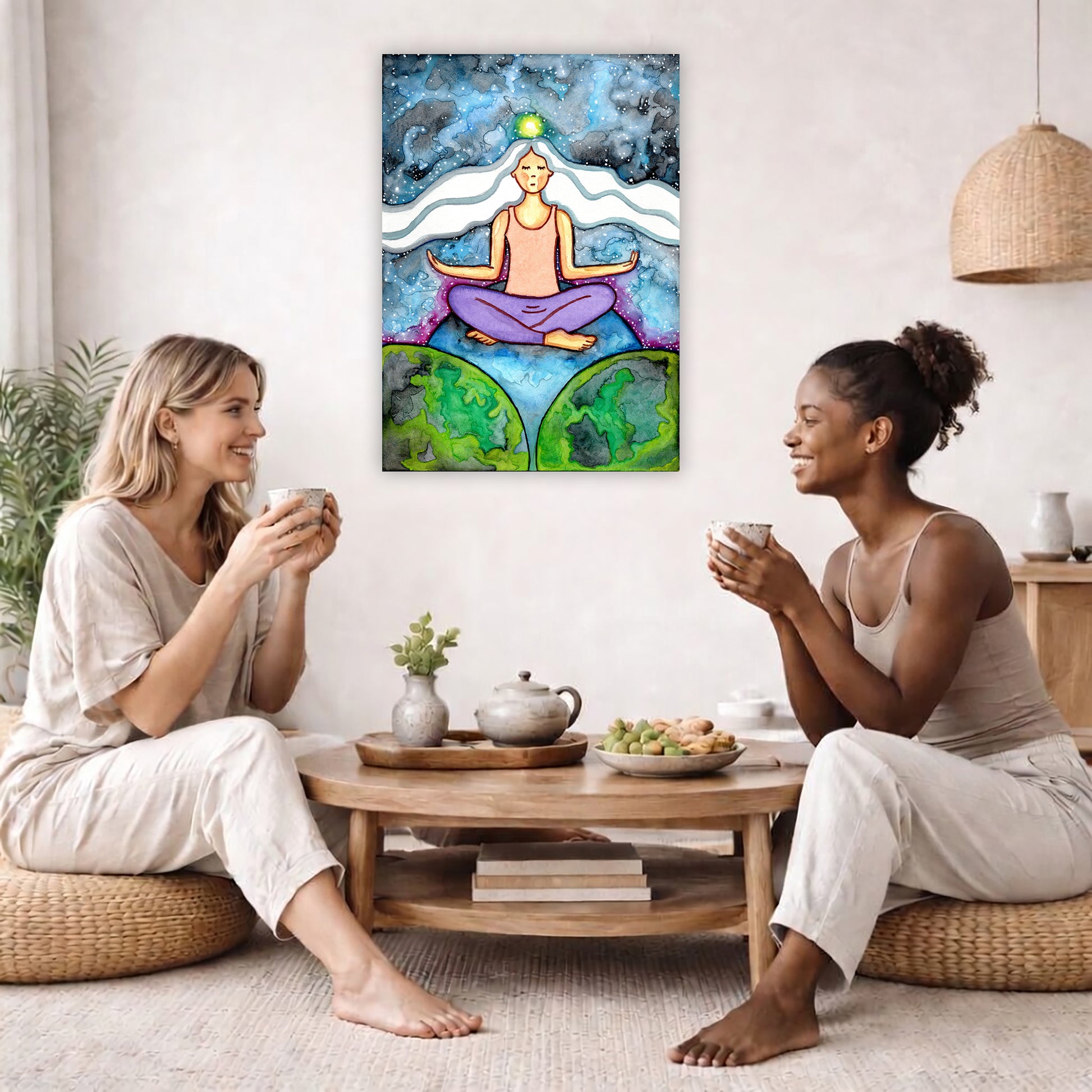 Woman with crown chakra glowing canvas poster. She is sitting on top of the world.  The poster is in the center of the living room wall. Two female friends are having tea, grapes and cookies on a coffee table in front of the poster. On the left there is a green potted plant and to the right there is a hanging lamp.
